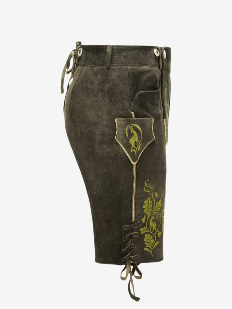 Side view of olive lederhosen featuring green embroidery, side pocket with flap, and adjustable lace-up hem.