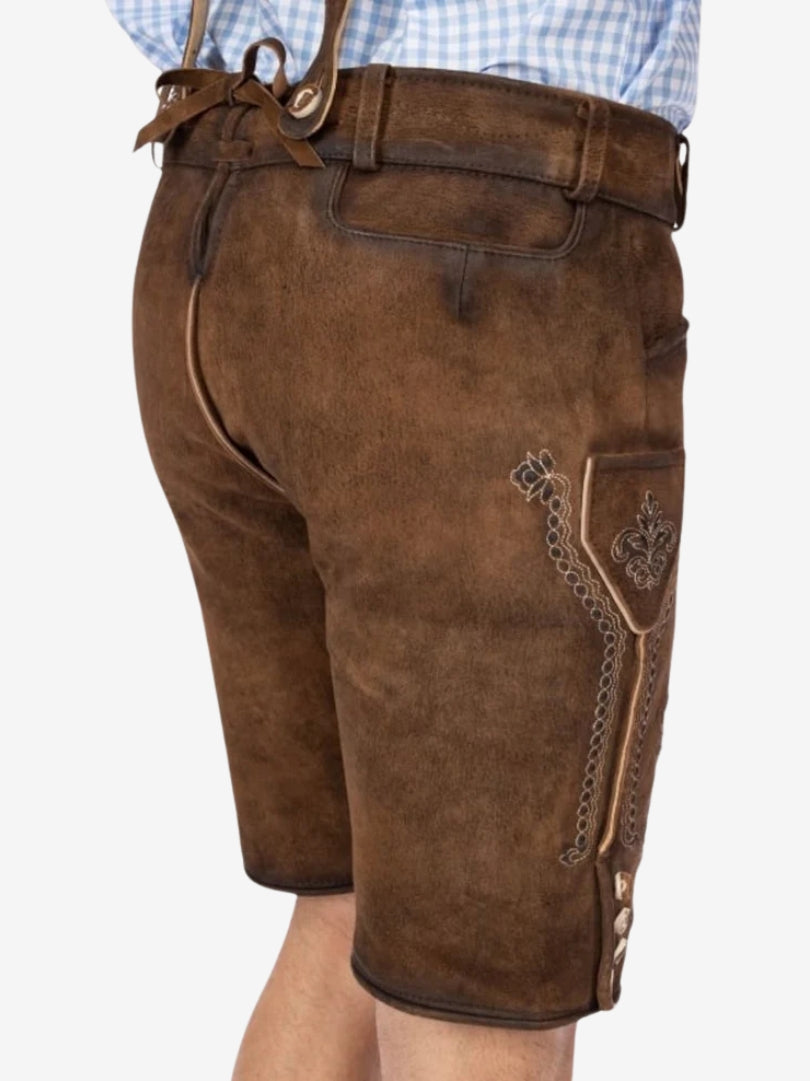 Angled rear view of lederhosen highlighting the back panel, suspenders, and subtle embroidery details near the side seam.