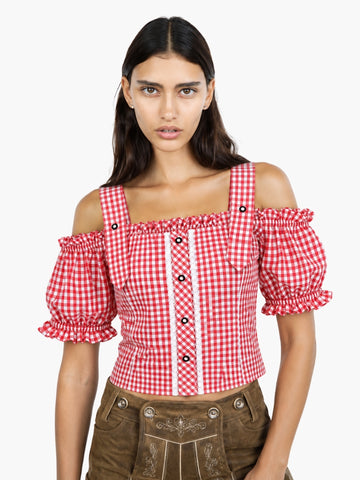 Women’s red gingham Oktoberfest blouse with puff sleeves, lace detailing, and fitted bodice styled with traditional lederhosen.
