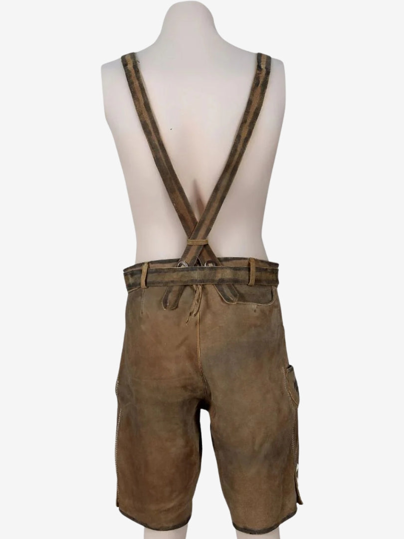 Back view of brown lederhosen with crossed suspenders, belt loops, and smooth suede finish.