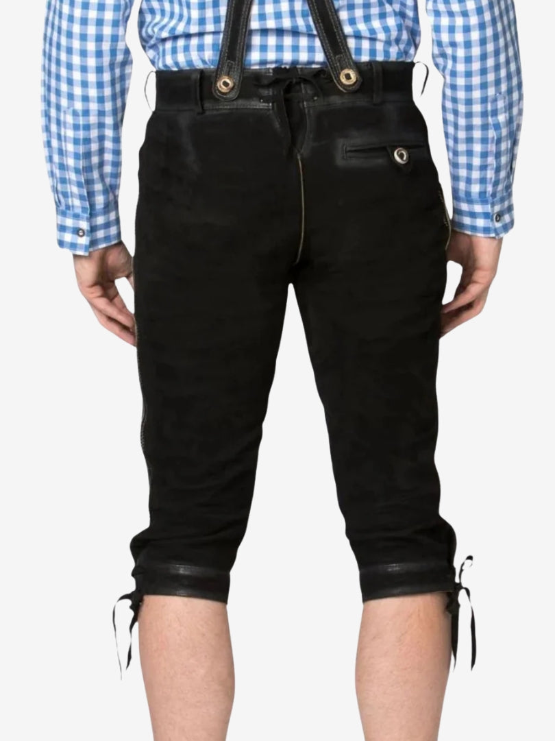 Back view of black bundhosen with suspenders, showing rear pocket, seam details, and knee-length design.