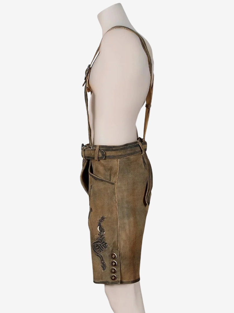 Opposite side view of brown lederhosen with suspenders, showing stitching, side pocket, and traditional design elements.