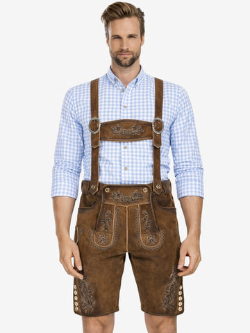 Man wearing brown embroidered lederhosen with suspenders and a light blue checkered shirt, standing against a plain background.