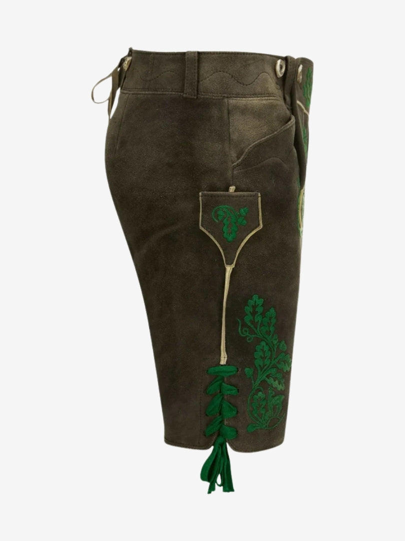 Side view of lederhosen with green embroidery, side pocket, and lace-up leg opening.