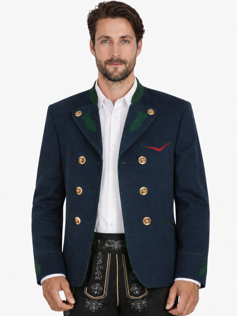 Man wearing navy blue Trachten jacket with green accents and gold buttons, paired with black lederhosen for an authentic Oktoberfest outfit.