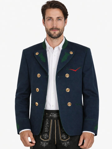 Man wearing navy blue Trachten jacket with green accents and gold buttons, paired with black lederhosen for an authentic Oktoberfest outfit.