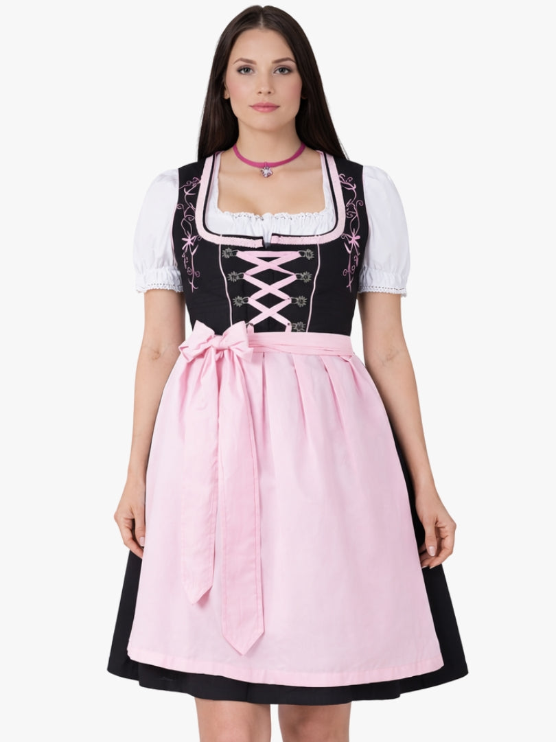 Front view of women's black and pink Bavarian dirndl dress with white blouse, lace-up bodice, and pink apron in traditional Oktoberfest style.