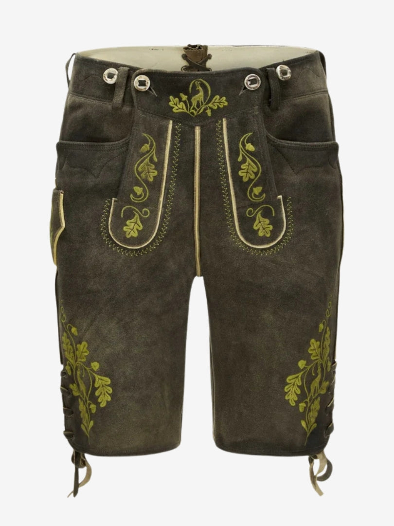 Man wearing olive green embroidered lederhosen with a white shirt, showcasing a classic Bavarian outfit.