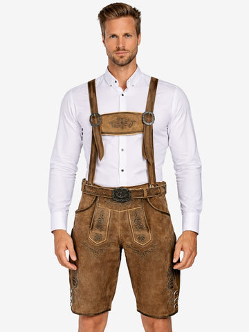 Man wearing brown lederhosen with suspenders and embroidery, paired with a white shirt and traditional belt.
