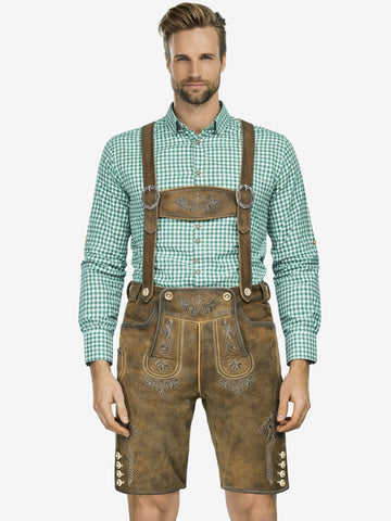 Man wearing light brown lederhosen with suspenders and a green checkered shirt, standing against a plain background.