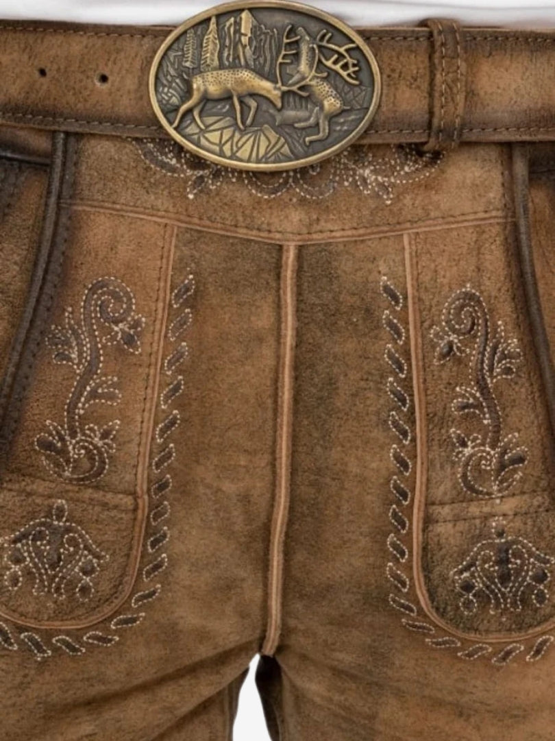 Man wearing tan suede lederhosen with subtle embroidery, paired with a white button-down shirt in traditional Bavarian style.