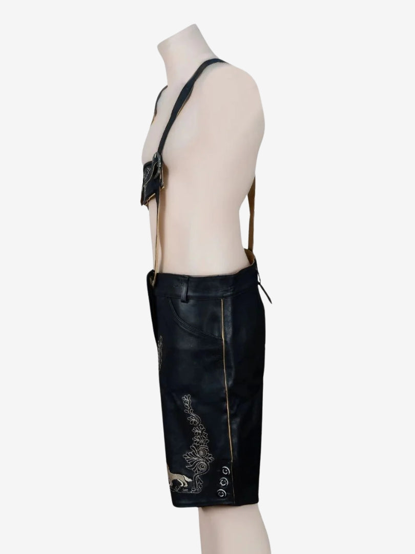 Side view of black lederhosen highlighting floral embroidery, side buttons, and structured fit.