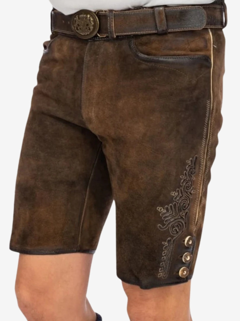 Angled front view of lederhosen with embroidered thigh patterns and classic Bavarian styling.