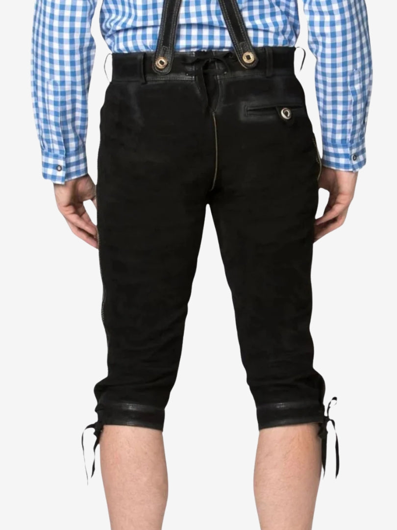Back view of black bundhosen worn by a model, showing waistband, back pocket, and knee-length fit.