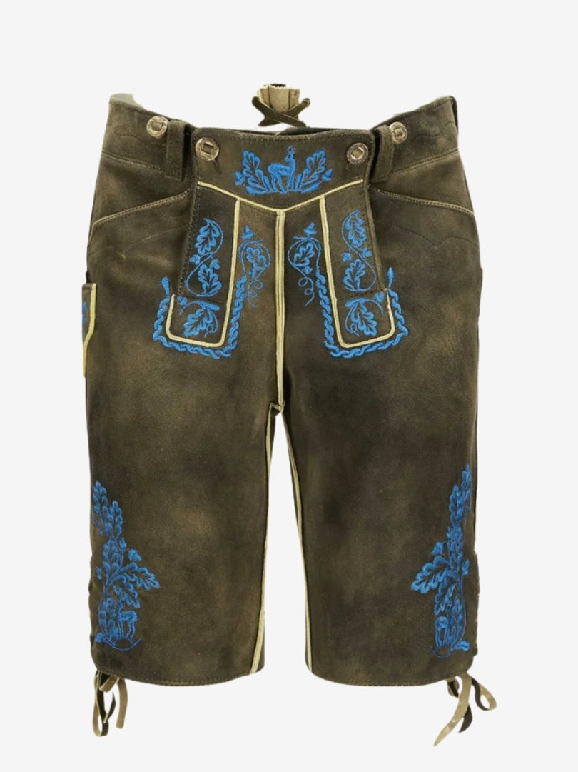 Man wearing dark brown lederhosen with vibrant blue embroidery paired with a white shirt in traditional Bavarian style.