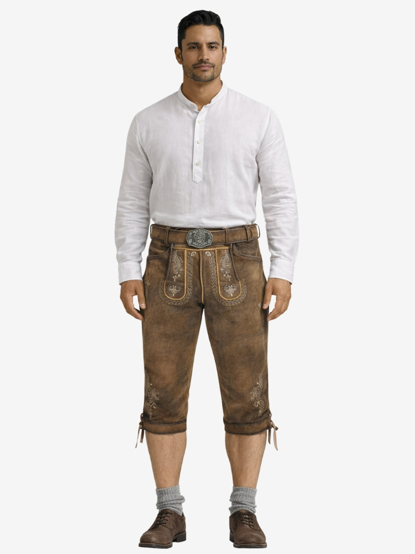Man wearing brown bundhosen with a white shirt, socks, and shoes in a full-length front view.