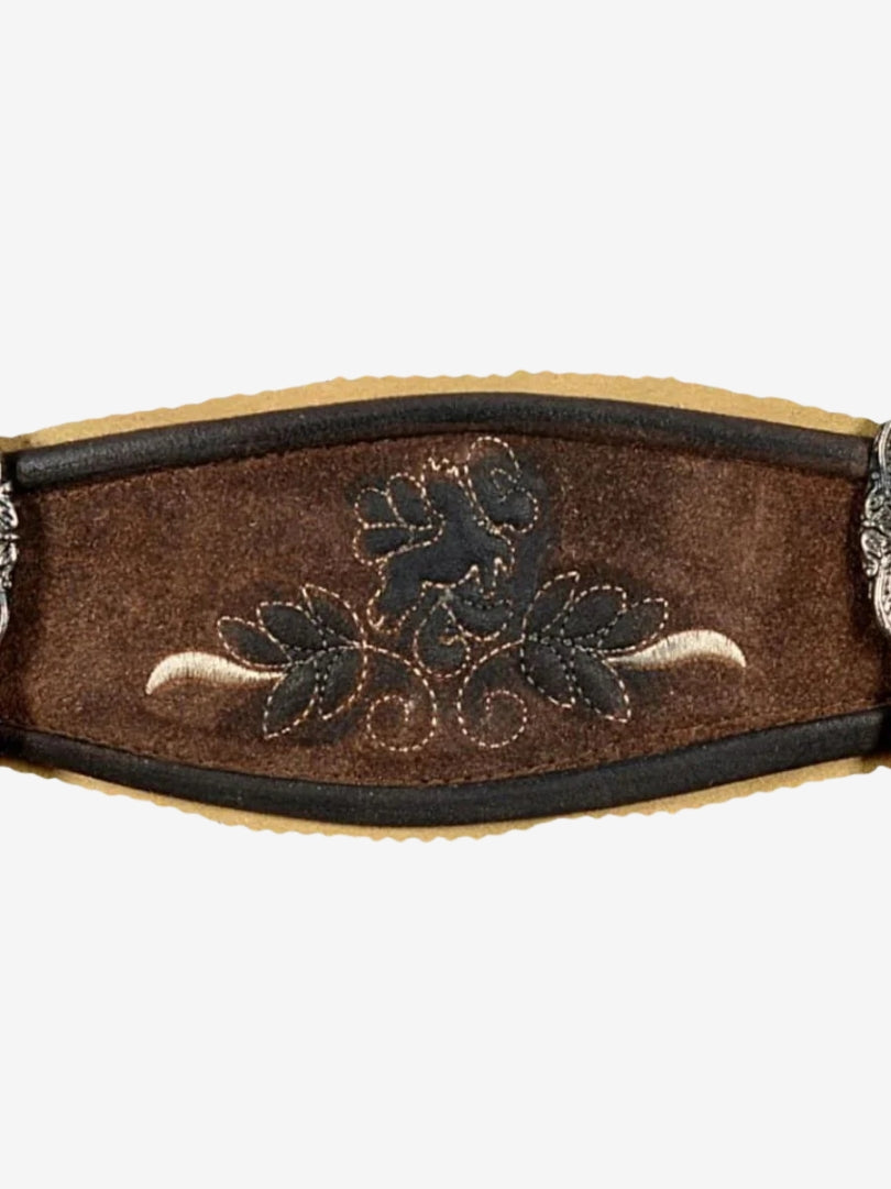 Close-up of embroidered chest panel on suspenders with floral design and contrast stitching.