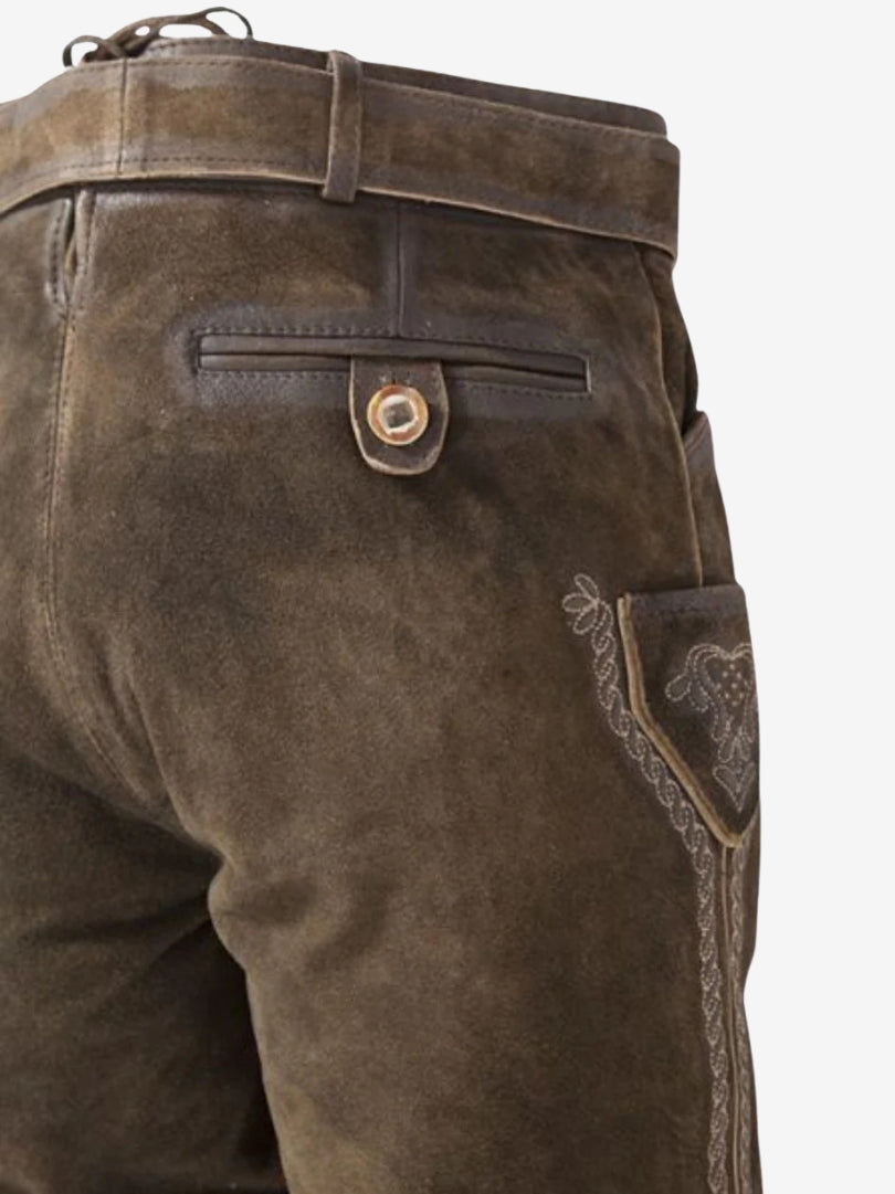 Back view close-up showing rear pocket with button closure, side pocket, and decorative stitching on brown leather bundhosen.