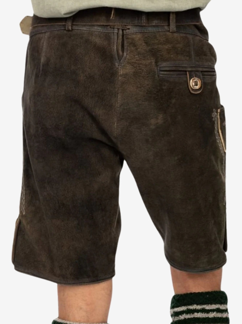 Back view of a man wearing dark brown lederhosen with traditional cut and clean stitching.