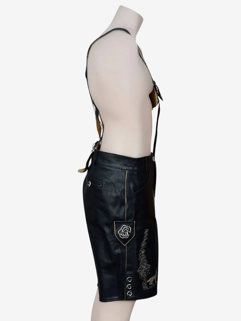 Opposite side view showing pocket detail, stitching, and decorative embroidery on black leather lederhosen.