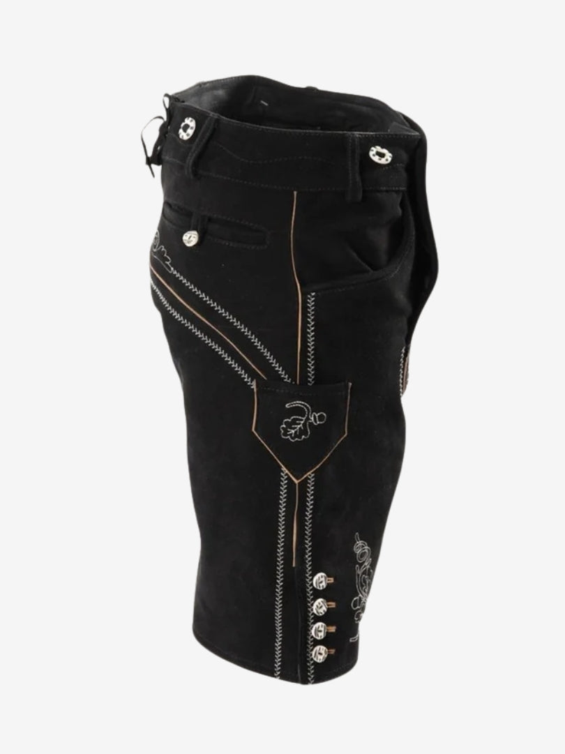 Side view of black lederhosen showing embroidered pocket detail, vertical stitching, and decorative buttons along the leg.