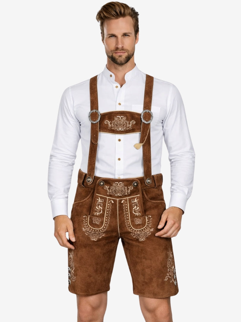 Man wearing traditional Bavarian lederhosen with a white shirt on a white background