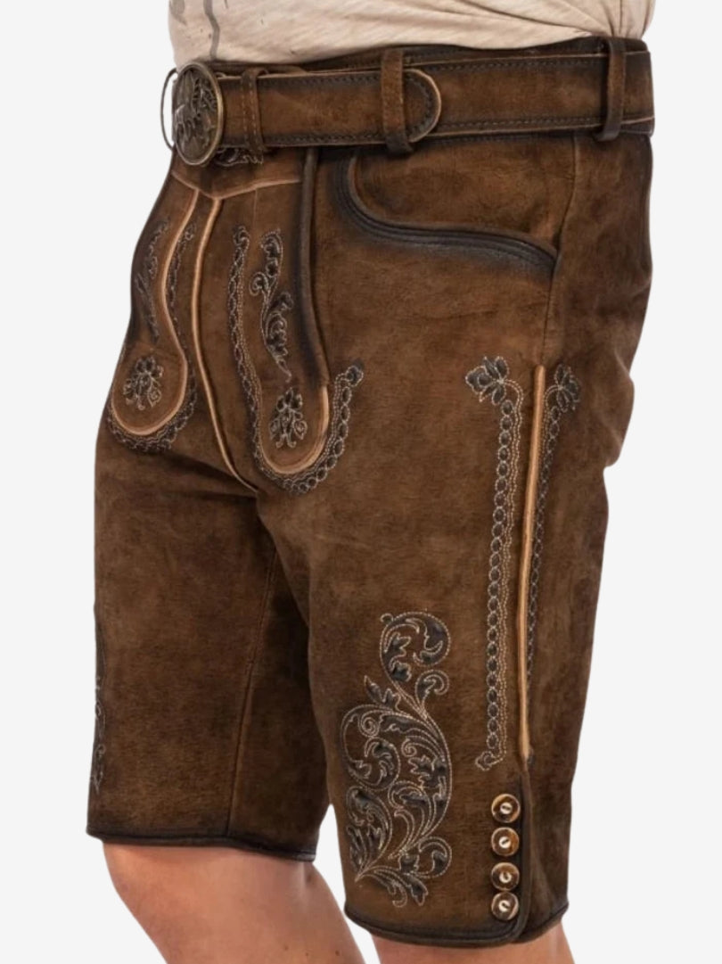 Angled view of brown lederhosen featuring embroidered patterns, front flap design, and classic Bavarian styling.