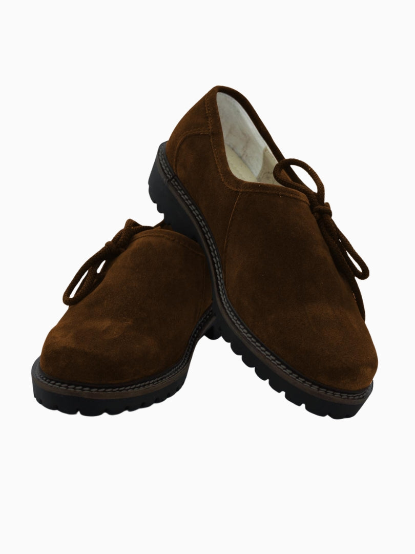 Pair of brown suede traditional Trachten shoes with lace-up front, round toe design, and black rugged sole, displayed on a white background.
