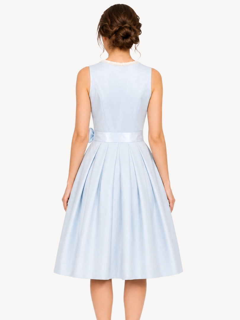 A woman shown from the back wearing a sleeveless light blue midi dress with a pleated skirt and a matching satin waistband, against a plain off-white studio background.