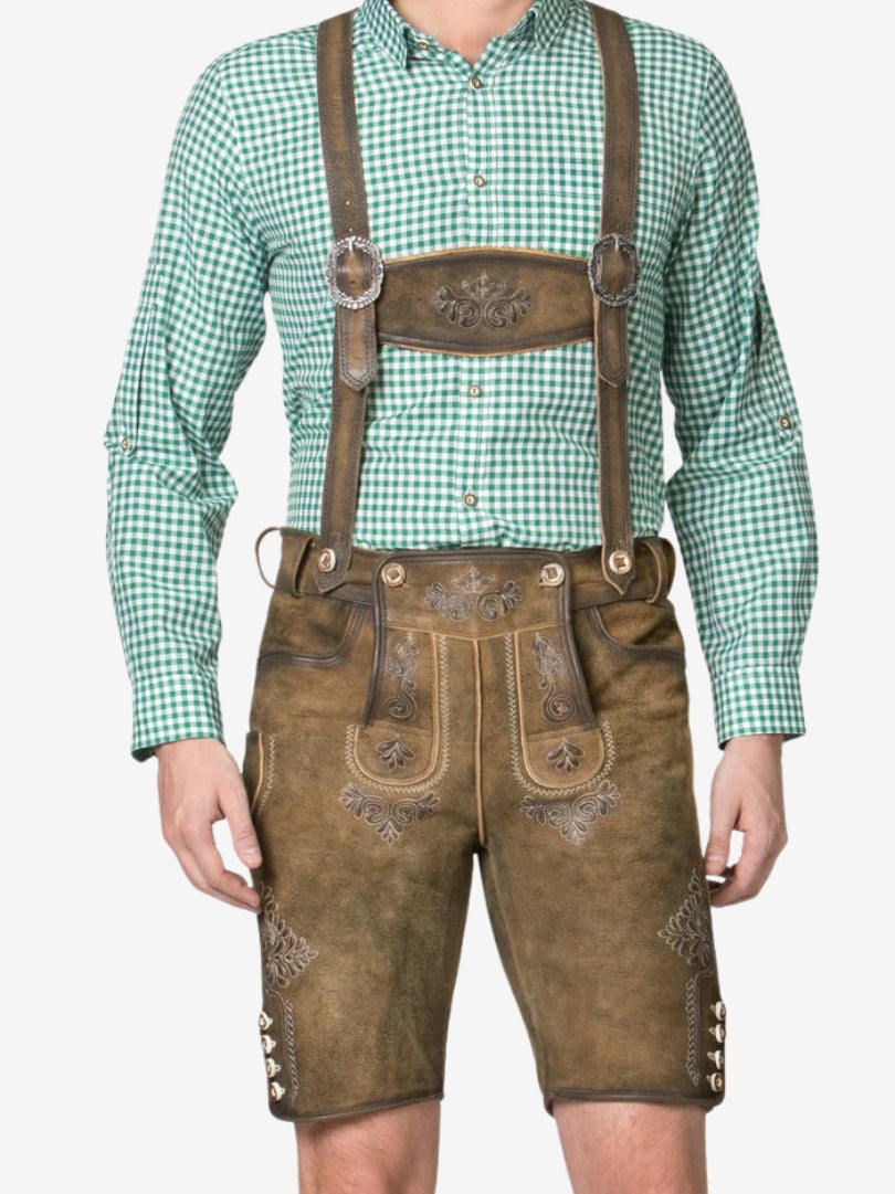 Front view of light brown embroidered lederhosen with suspenders, highlighting detailed stitching and traditional flap design.