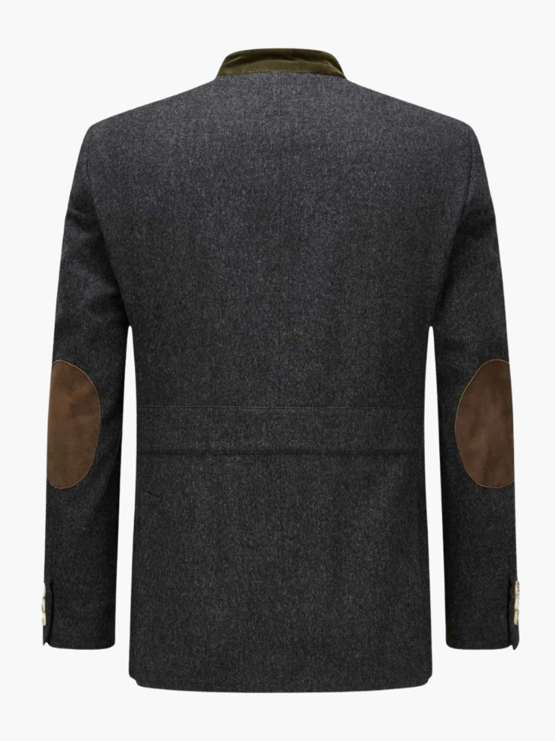 Rear view of traditional Bavarian jacket featuring tailored fit, green velvet collar, and brown elbow patch details.
