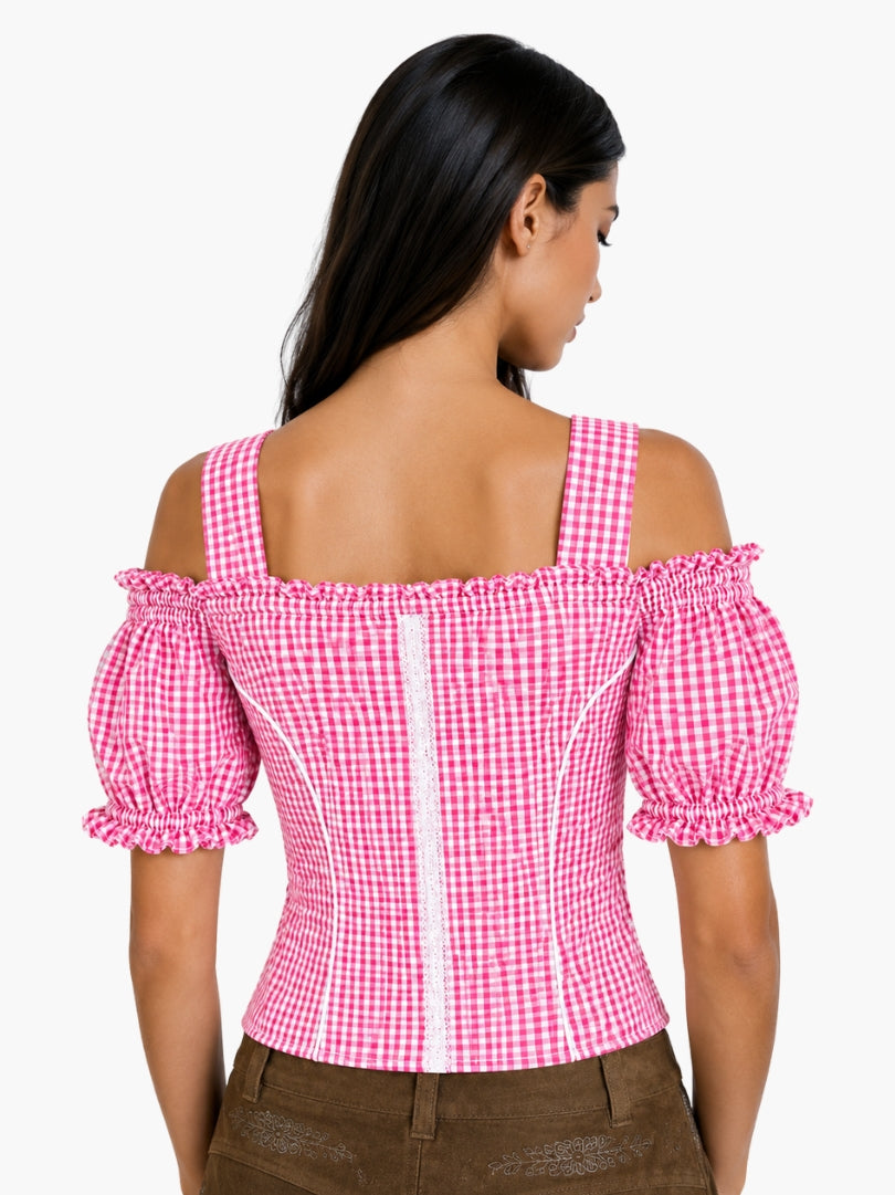 Women’s pink gingham Oktoberfest blouse with puff sleeves, lace trim, and traditional Bavarian styling paired with lederhosen.