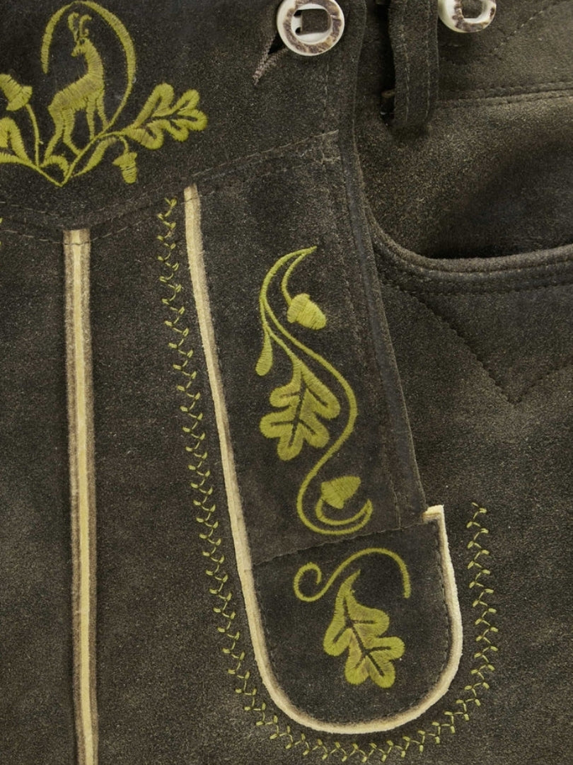 Close-up of front flap and pocket area highlighting intricate green embroidery and contrast stitching.