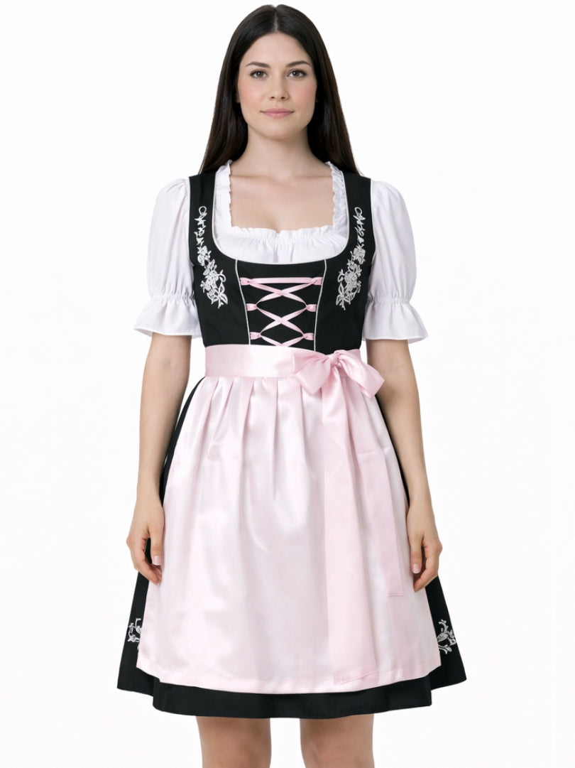Front view of women's black Bavarian dirndl dress with white blouse, pink lace-up bodice, and pink apron in traditional Oktoberfest style.