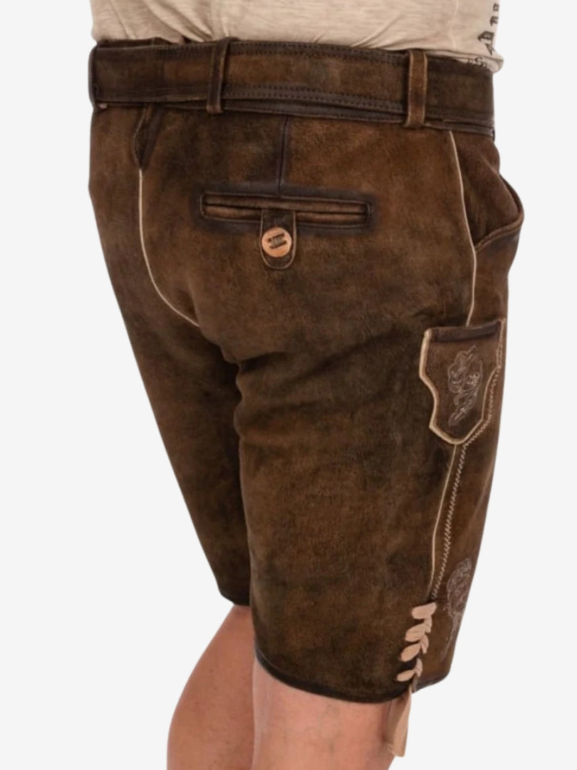 Rear side view of brown lederhosen featuring back pocket with button closure, belt loops, and detailed side panel stitching.