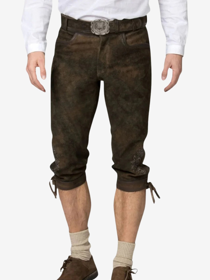 Close-up of brown bundhosen worn with a white shirt, highlighting fit, texture, and embroidered details near the knees.