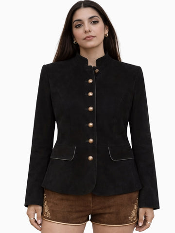 Elegant womens black Bavarian Trachten jacket featuring a structured tailored fit, stand-up collar, and decorative gold-tone buttons, paired with traditional brown lederhosen shorts, ideal for Oktoberfest and Alpine heritage wear.