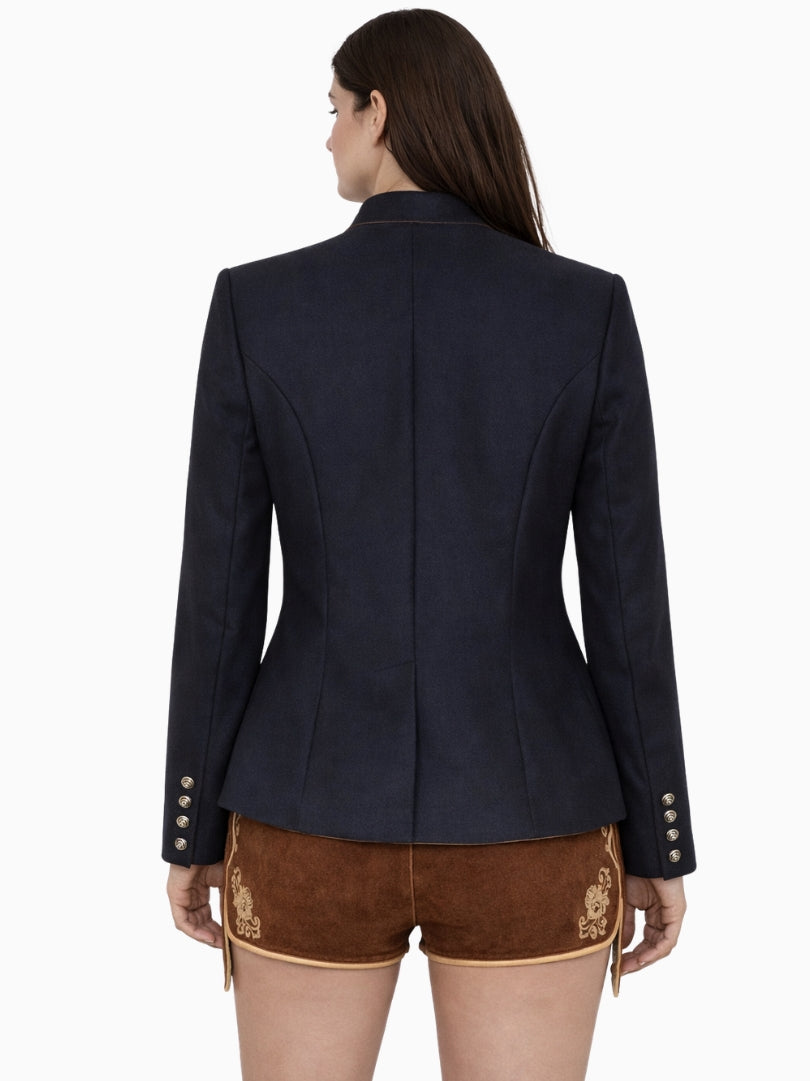 Front view of women's navy blue Bavarian Trachten jacket featuring traditional metal buttons, stand collar, tailored silhouette, and classic alpine heritage design with brown lederhosen shorts.