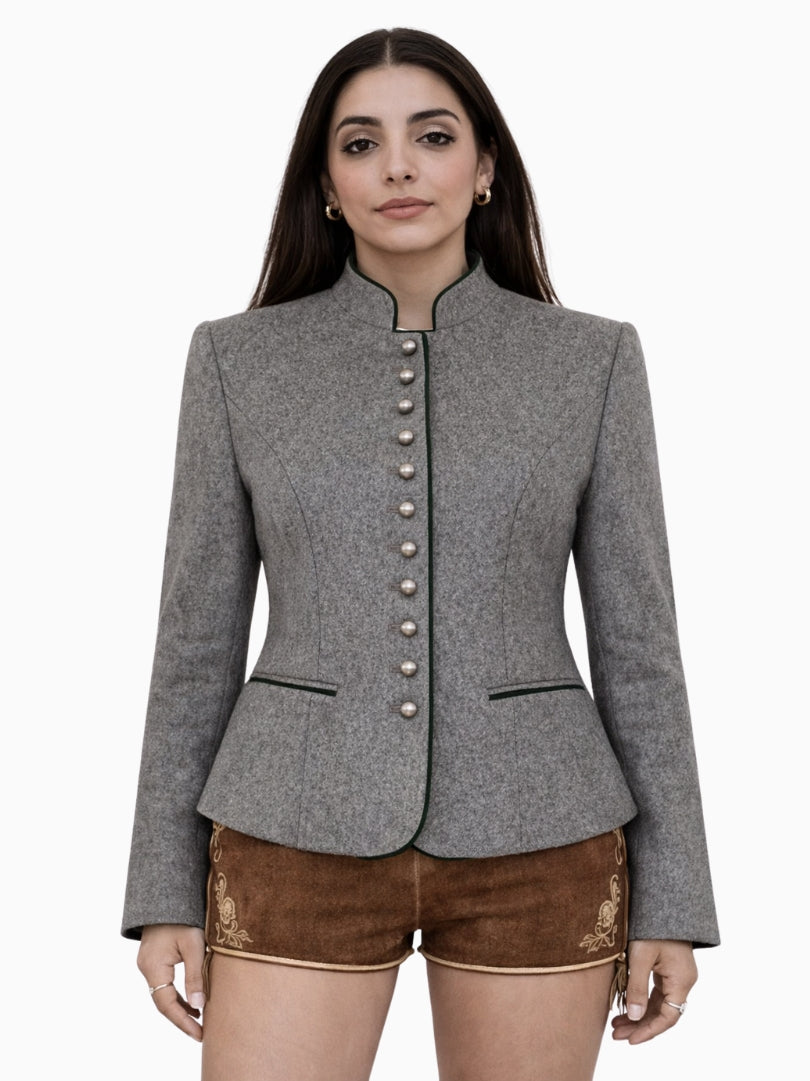 Womens grey Bavarian Trachten jacket with green trim, stand collar, silver buttons, tailored fit, and decorative brown leather shorts, front view.