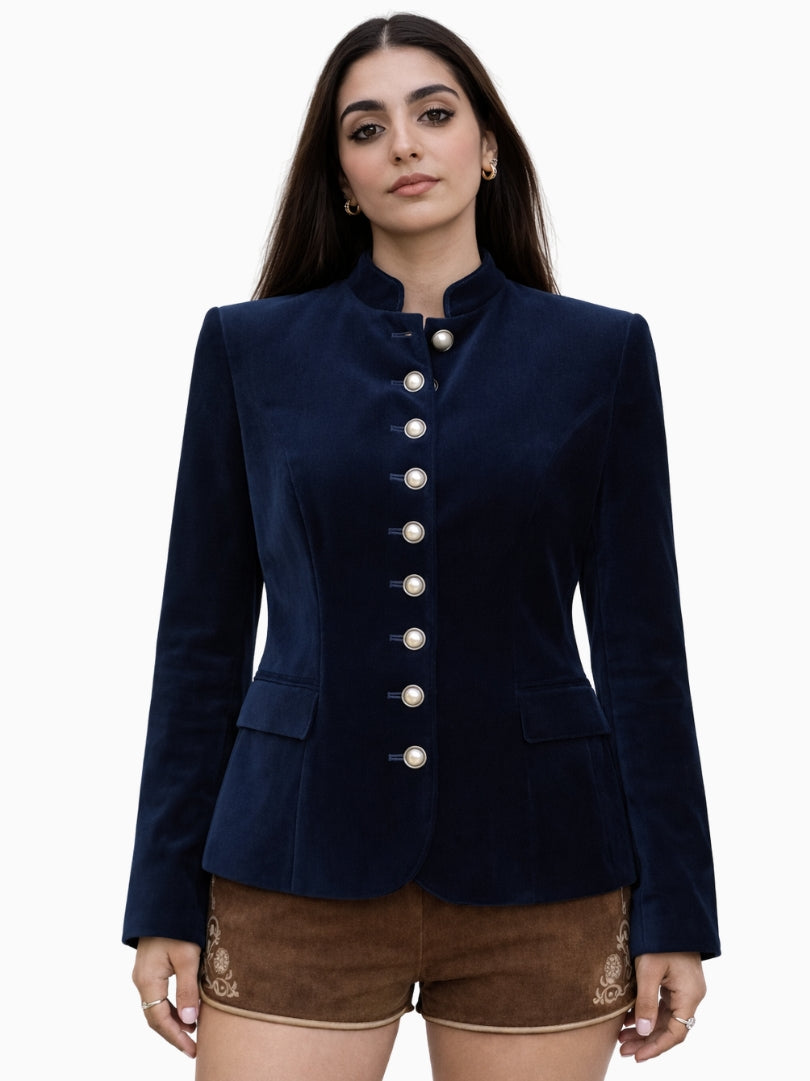 Women’s navy blue velvet Bavarian Trachten jacket with silver buttons, fitted waist, and traditional Alpine design paired with embroidered lederhosen shorts.