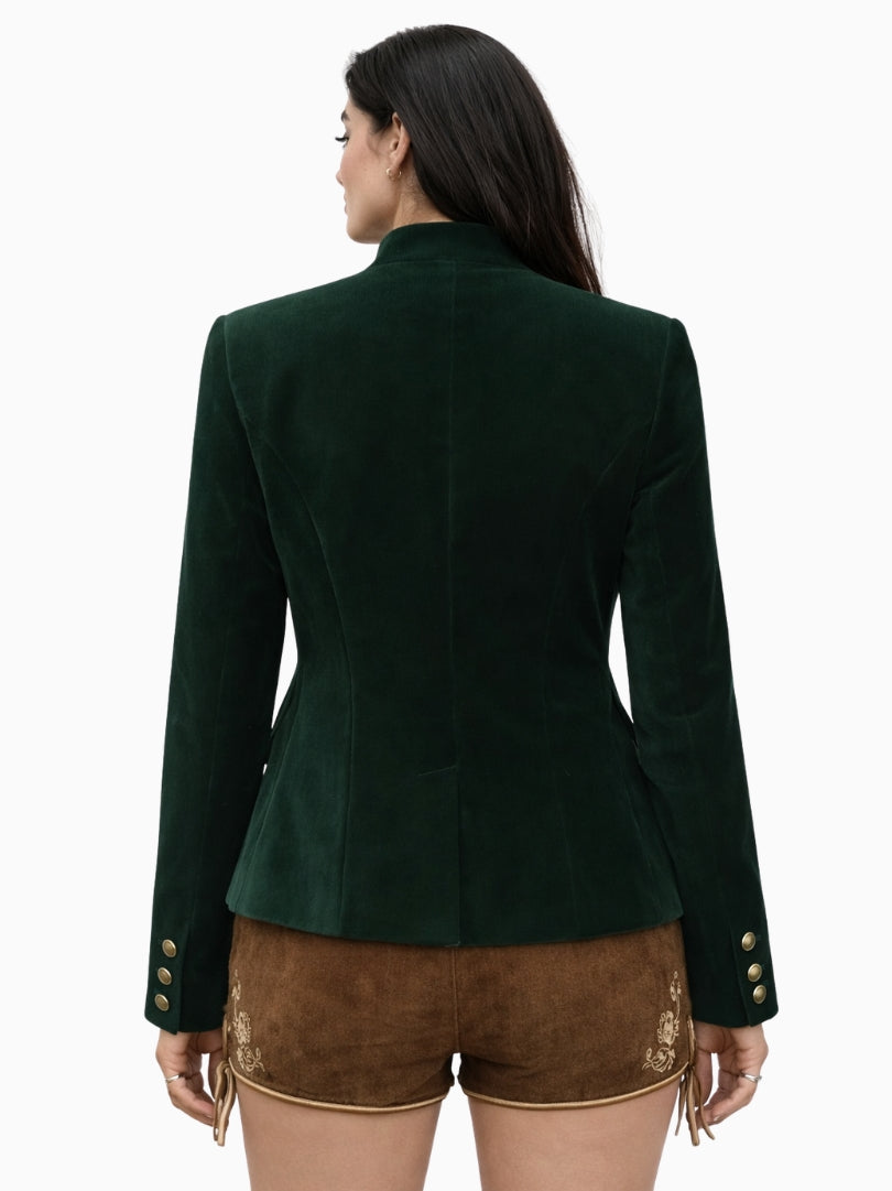 Back view of women's dark green velvet Bavarian Trachten jacket with structured tailored fit and long sleeves, paired with traditional brown embroidered lederhosen shorts