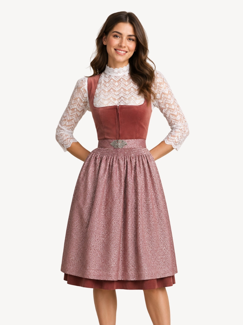Dusty rose Oktoberfest dirndl dress with white lace blouse, fitted bodice, patterned apron, and pleated skirt.