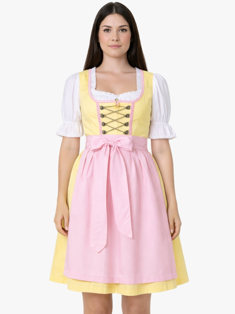 Front view of women's yellow dirndl dress with white blouse, lace-up bodice, and pink apron in traditional Oktoberfest style.