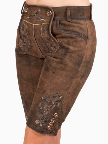 Close-up front view of rustic brown traditional lederhosen-style shorts featuring embroidered patterns on the decorative front flap and contrast piping details.