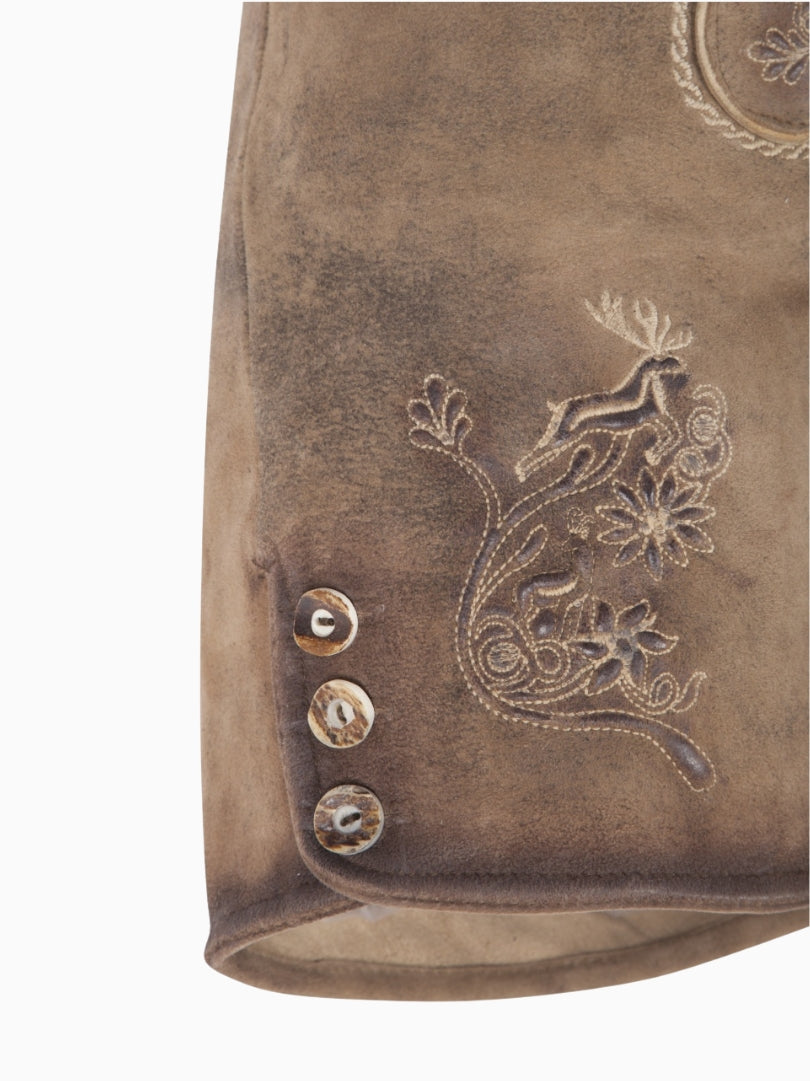 Close-up side view of light brown leather lederhosen shorts showing floral and deer embroidery with decorative horn-style buttons on the hem.