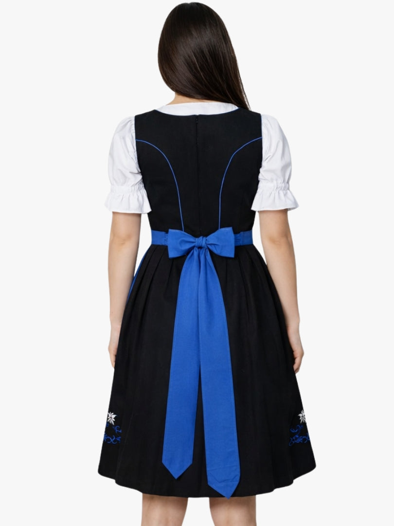 Back view of women's traditional black dirndl dress with white blouse and blue apron bow detail.