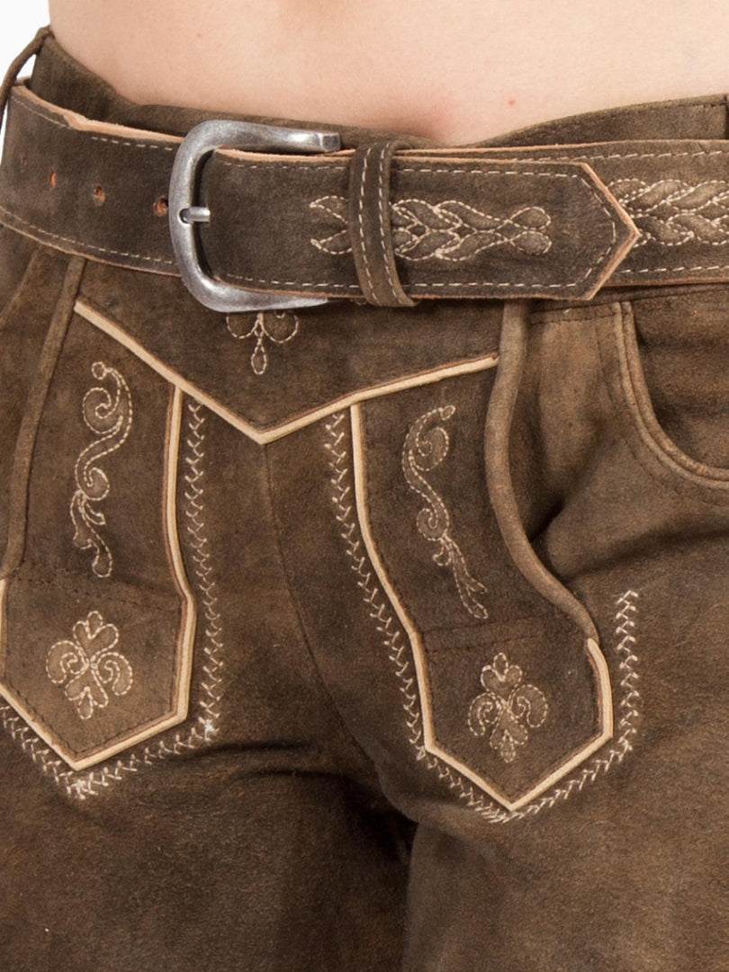 Close-up of embroidered front flap on women's traditional brown lederhosen shorts with decorative stitching