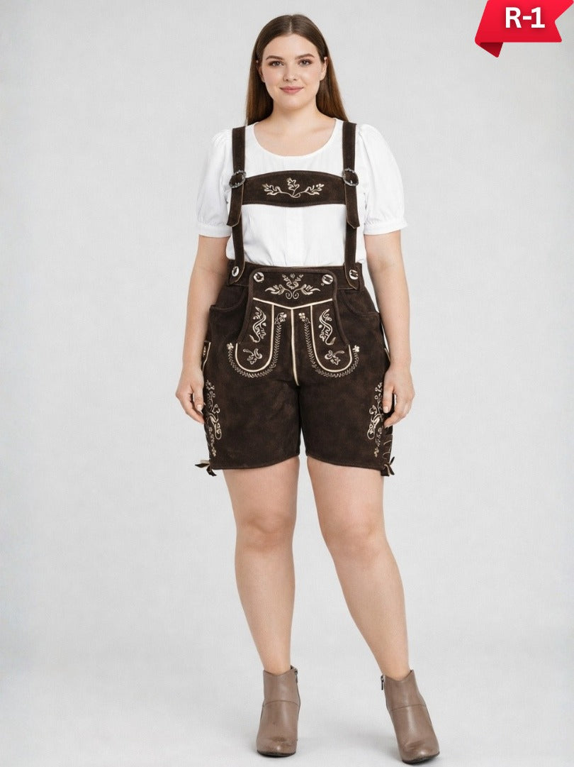Plus size women wearing traditional Bavarian lederhosen in brown suede with embroidered suspenders, white blouse, and ankle boots, full-length studio image.